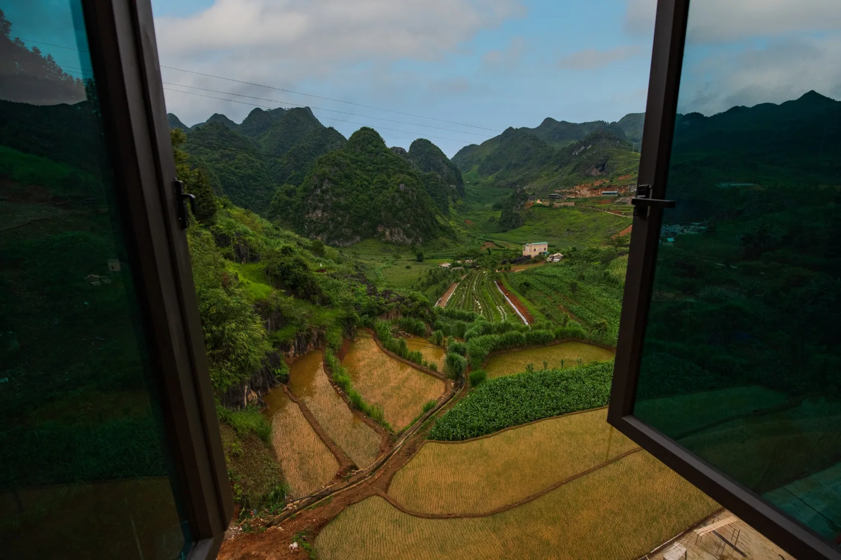 Khung cảnh núi và ruộng nhìn từ cửa sổ